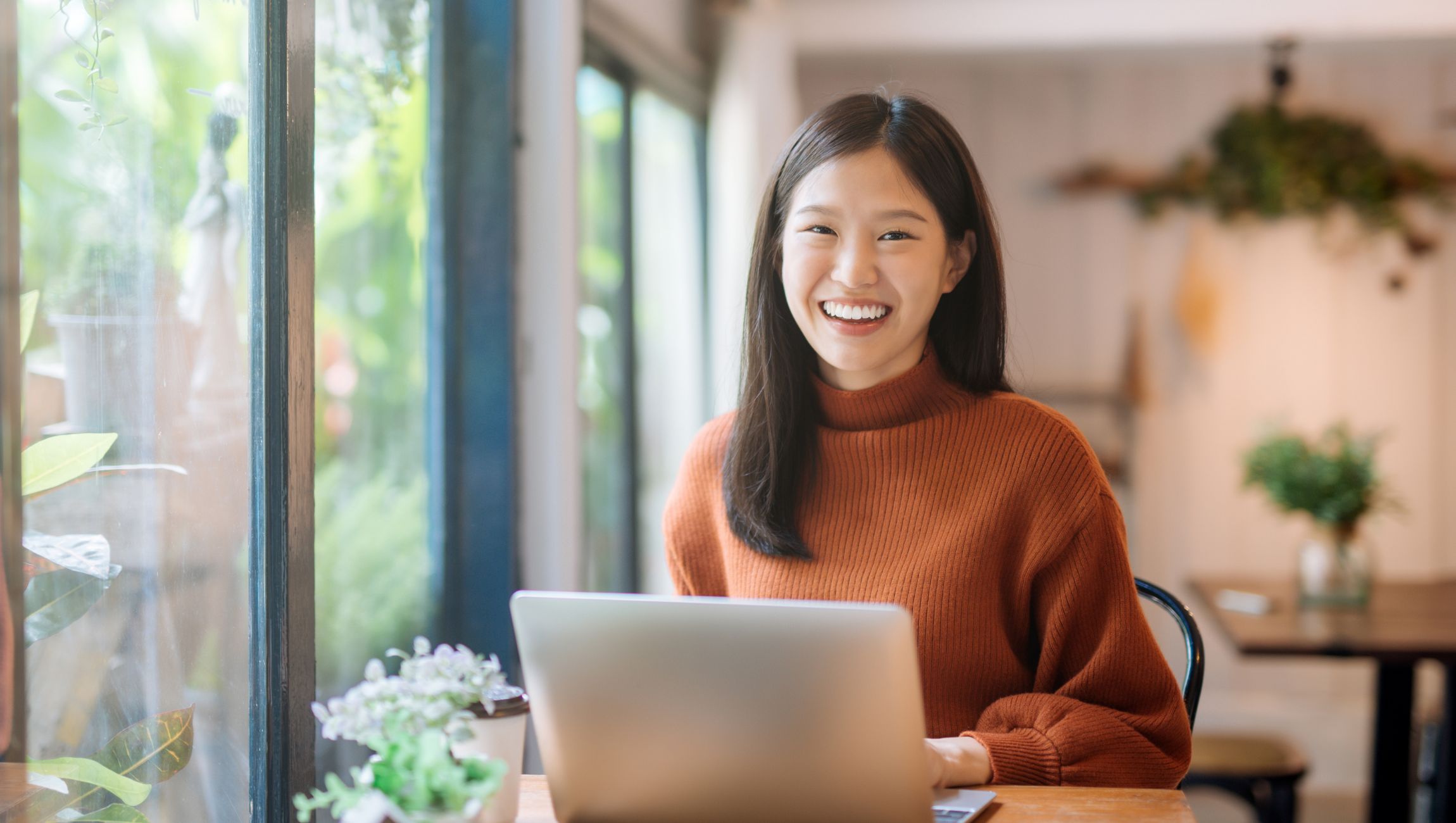 adult female sitting at a laptop computer