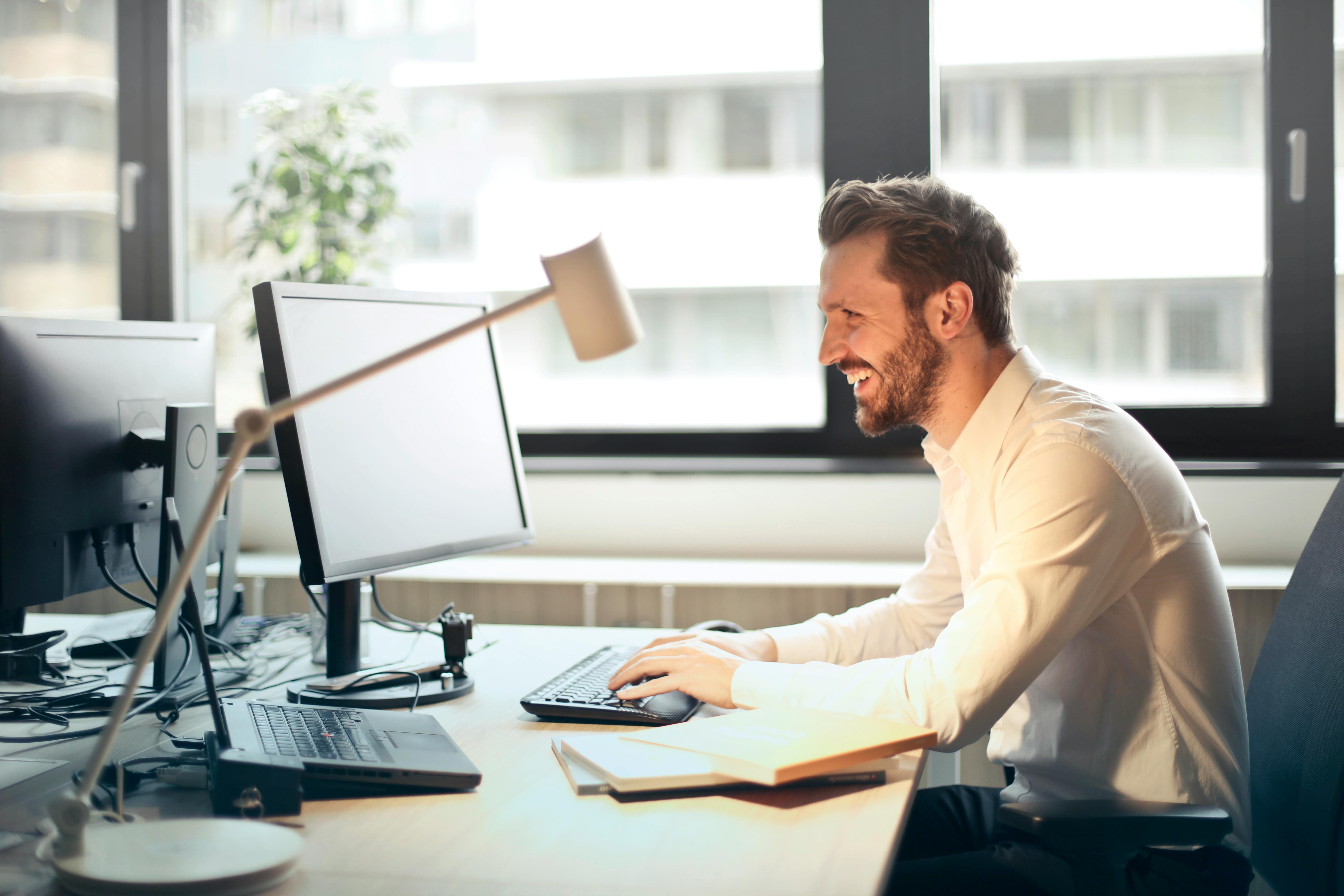 a man sitting at a computer smiling