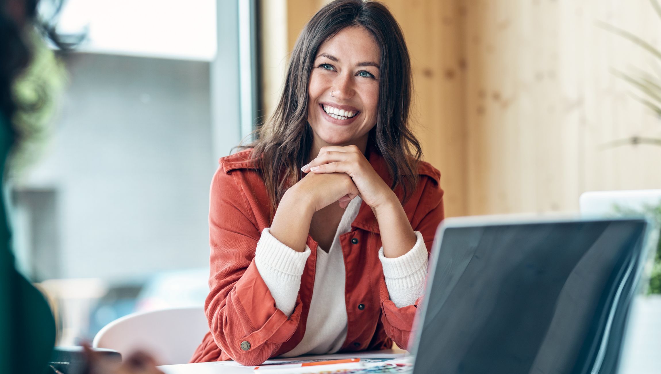 woman in orange jacket smiling