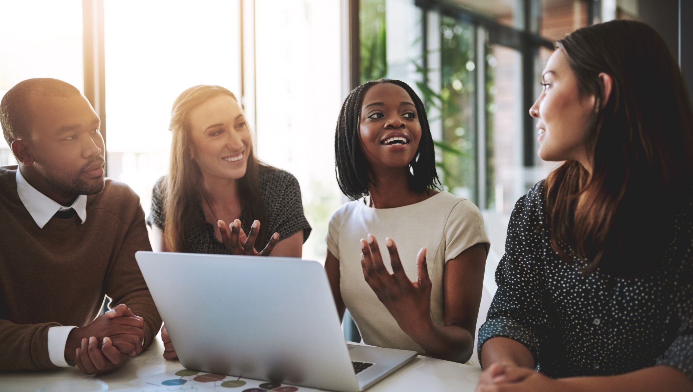 group of young adults sitting at a computer